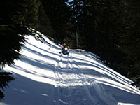 Jason Traversing a Slope on a Snowmobile