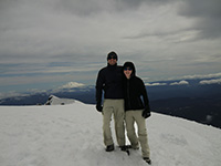 Katie and Jason on Summit Rim of Mount St. Helens with Mount Adams in the Background