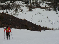 Matt Skiing Up Middle Sister with Camp in the Background Below