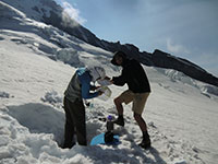 Matt and Louis Melting Snow and Analyzing Topo Maps at Camp