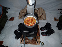 Chicken, Corn, and Salsa Cooking in Dutch Oven on the Wood Stove