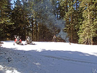 Relaxing in the snow with a campfire