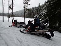 Julian and Katie snowmobiling at Frog Lake