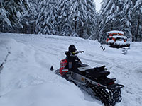 Unloading the snowmobiles at Marble Mountain SnoPark