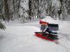 Picture of snow camping gear hauled in by snowmobile